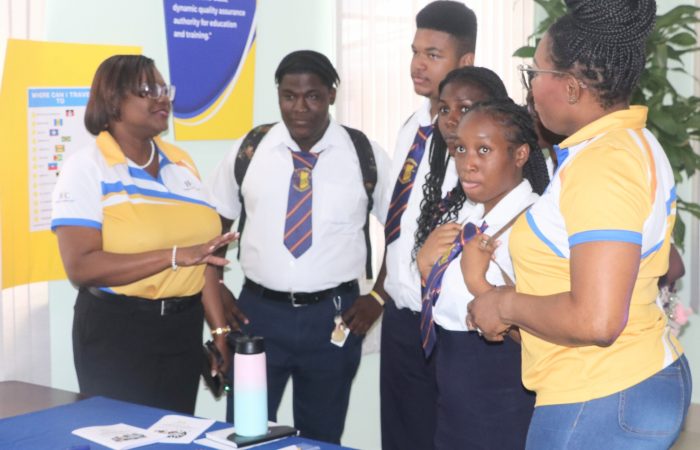 BAC’s Executive Director Lisa Gale and (left) and Administrative Officer Requell Griffith (right) interact with students of the Daryll Jordan Secondary School during the Council’s Open Day.