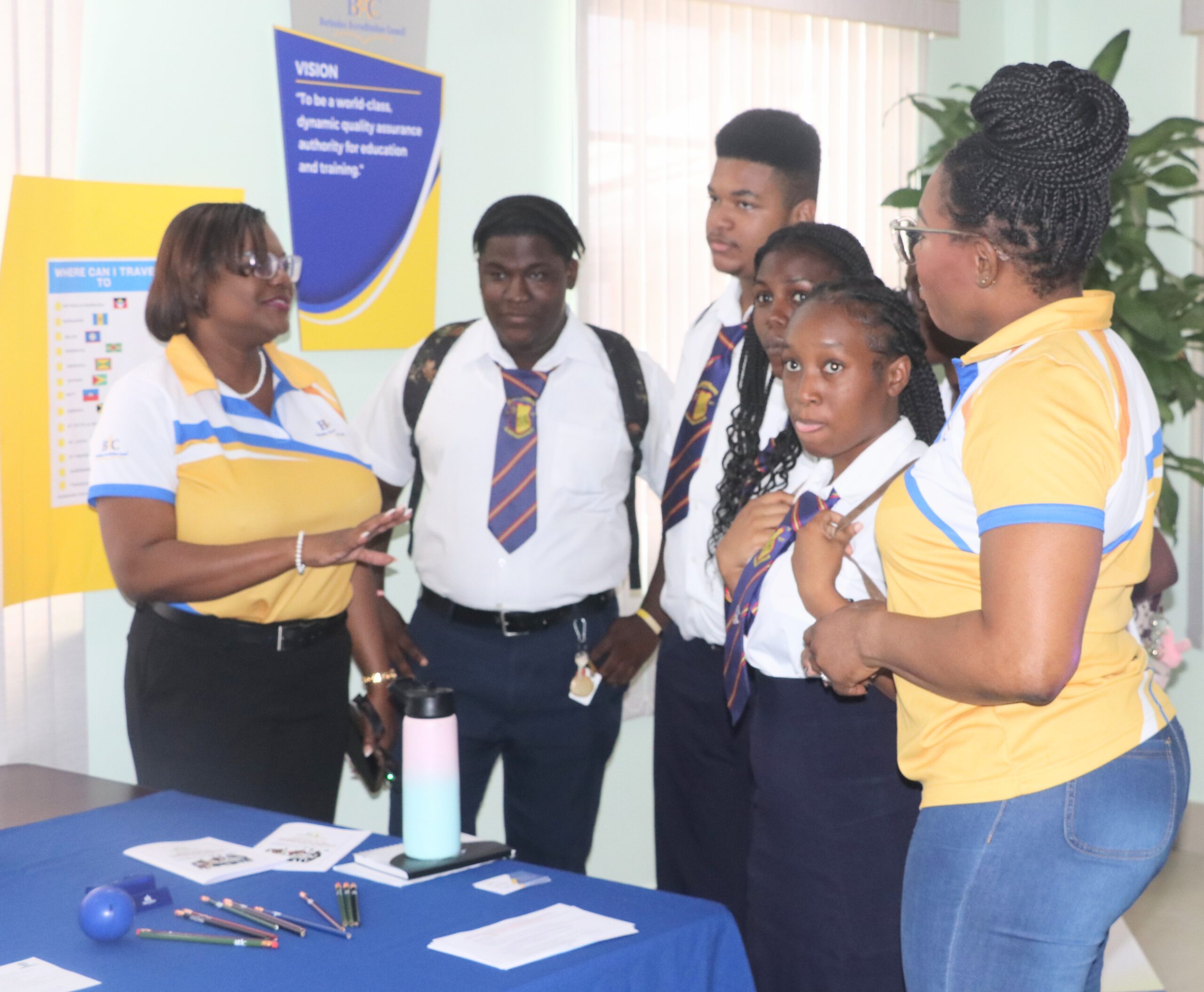 BAC’s Executive Director Lisa Gale and (left) and Administrative Officer Requell Griffith (right) interact with students of the Daryll Jordan Secondary School during the Council’s Open Day.