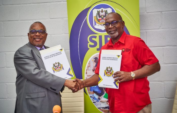 SJPI Principal Ian Drakes (left) and Managing Director of United Commercial Autoworks Limited Pedro Stanford shaking hands moments after signing the MOU.