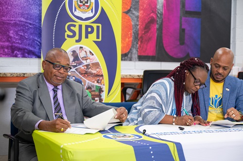 Mr. Ian Drakes, Principal of the Samuel Jackman Prescod Institute of Technology (SJPI), and Sonia and Mark Corbin, Founders of the Markonia Foundation, sign a memorandum of understanding during a ceremony in the Media Resource Centre, marking an important collaboration in education and scholarship opportunities.