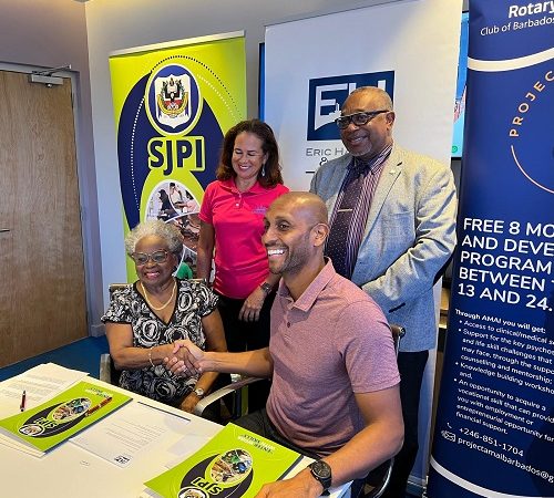 Mr. Mark Hassell, Mr. Ian Drakes, and Ms. Arlene Ross signing the MOU.