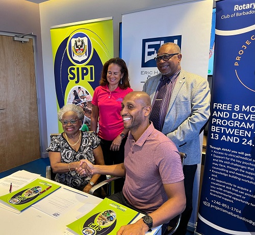 Mr. Mark Hassell, Mr. Ian Drakes, and Ms. Arlene Ross signing the MOU.